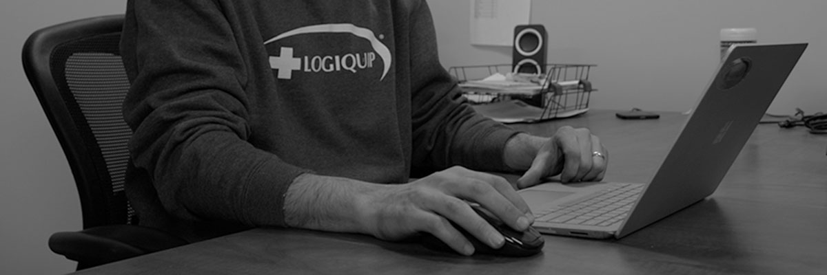 LogiQuip employee sitting in front of laptop